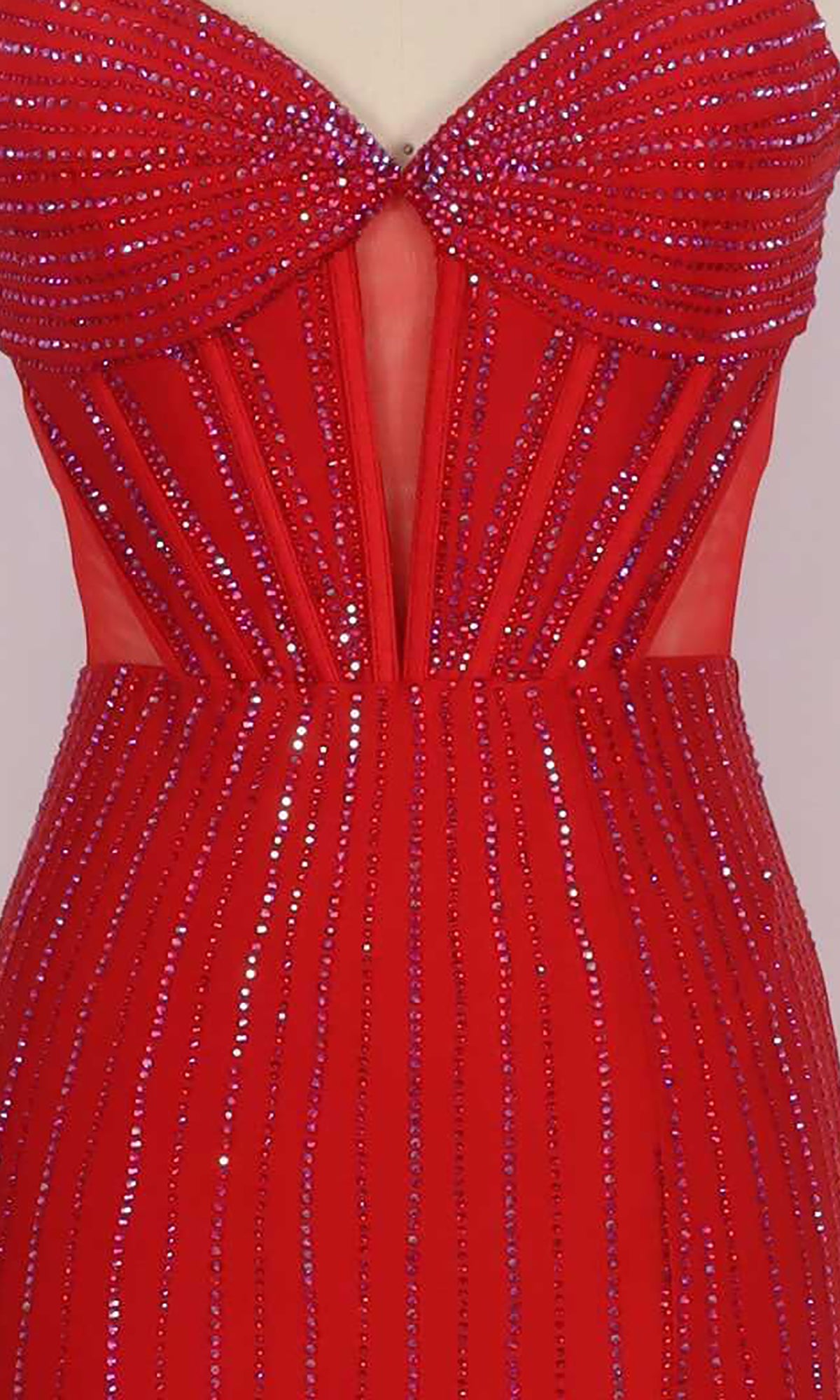 Close-up of the Sheer Cut-Out Prom Dress: PromGirl Exclusive 250054, a red strapless gown featuring vertical red and silver sequins and a sheer V-shaped panel at the bodice.